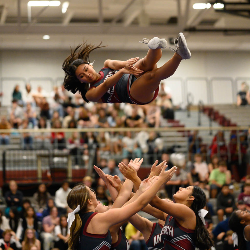 Cheerleaders catch a flier at the Homecoming Pep Rally in the North Gym on Friday, Sept 16