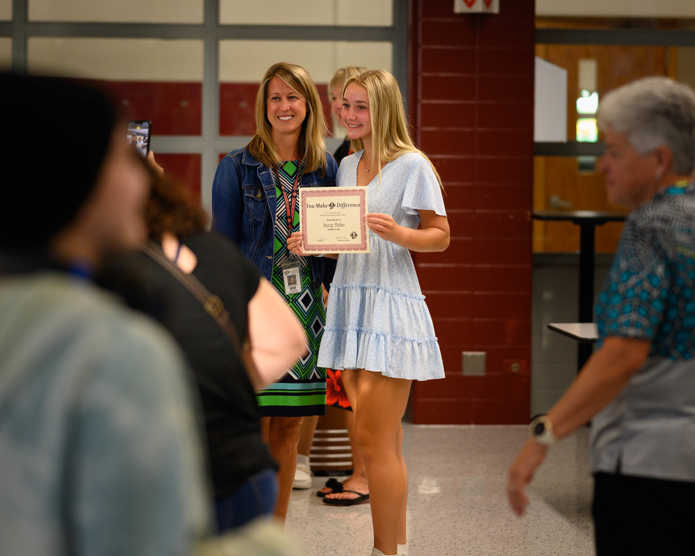 Student Jazzy Fisher and teacher Teri Klobnak pose for a photo after the first YMAD breakfast of the school year.