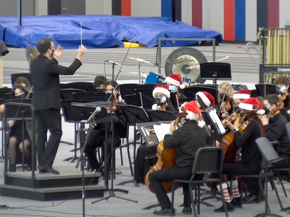 Mr Riggs conducts the ACHS orchestra in the D117 Field House