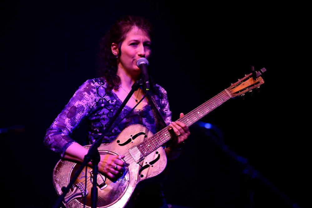 Donna Herula with Guitar at Storytellers Series in March