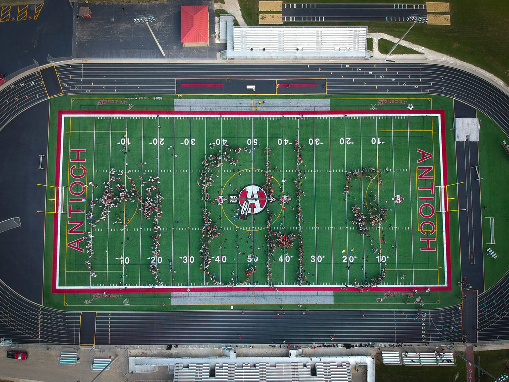 Aerial image of A C H S spelled in student bodies in the main stadium